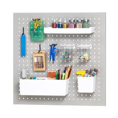 the peg board is organized with craft supplies