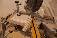 a circular table sawing on top of a piece of wood