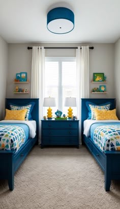 two twin beds in a bedroom with blue and yellow decor on the beddings