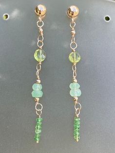 Spring splash! Beautiful green gemstones wire wrapped meticulously with 14k gold filled wire. 14k gold filled posts. Earrings hang 2 inches from post. Gemstones are aaa luxe quality.  Gemstones include: Peridot Chrysoprase Psavorite green garnet Green 14k Gold-filled Dangle Earrings, Green 14k Gold Filled Dangle Earrings, Green 14k Gold Filled Earrings With Ear Wire, Handmade Green 14k Gold Filled Earrings, Luxe Jewelry, Green Garnet, Earring Ideas, Lovely Necklace, Green Earrings