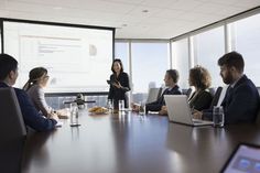 a group of people sitting around a conference table