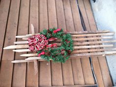 a wooden sled with a wreath hanging on it