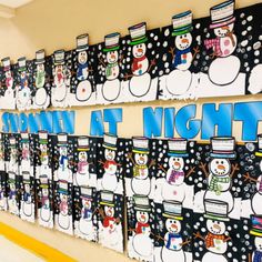 a bulletin board with snowmen on it and the words night at school written in blue