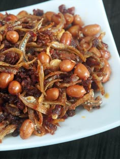 a white plate topped with beans and onions