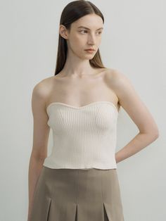 Editor's NotesThis is a knit bustier top in which the knitted fabric of the bust line and the front line are knitted in a three-dimensional sense. It is a coordinating item that looks fashionable when worn over a shirt or ribbon T-shirt.- Slim fit makes the waist look slim- Unique styling items for fall and winter- Available in 3 colors: Ivory, Blue, Gray*The color of the product may differ from the actual color depending on the device and resolution used.Measurements(in.)ONE SIZE (XS-M)- Length (Based on chest line): 11.02 in.- Length (Based on back center): 9.06 in.- Chest: 11.22 in.- Waist: 11.02 in.- Hem: 11.02 in.- Bust line rib height: 0.39 in.*Model size: Height 5'74, Bust 32.5, Waist 25, Hips 37*The size of the product may have an error of 0.39 to 1.18 inch depending on the measure Fitted Beige Tops With Built-in Bra, Chic Bandeau Top With Built-in Bra, Fitted Sleeveless Textured Knit Top, Fitted Textured Knit Sleeveless Top, Chic Fitted Textured Knit Tank Top, Chic Textured Knit Fitted Tank Top, Fitted Beige Knitted Tops, Fitted Knitted Beige Tops, Seamless Cropped Beige Top