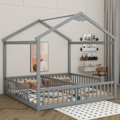 a baby's room with a bed, crib and desk