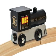 a wooden toy train with the number 1225 on it