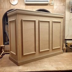 a large wooden cabinet sitting on top of a table