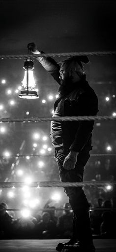 a man standing on top of a skateboard under a light