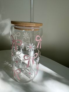 a clear glass jar with pink bows on it