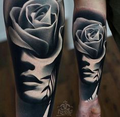 a man's leg with black and white tattoos on it, featuring a rose