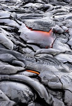 there is a lot of rocks that are covered in ice and orange light from the water