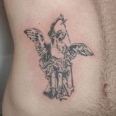 a man with a tattoo on his stomach holding an angel above his head and looking down at the ground