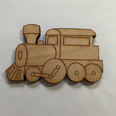 a wooden train ornament on a white background