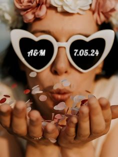 a woman wearing heart shaped sunglasses with confetti in front of her face and the words mr and mrs on them