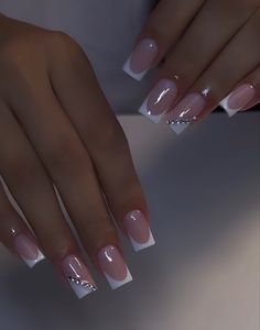 a woman's hands with french manies and nail polish on their fingertipss