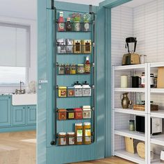 an open pantry door in a kitchen with blue walls and shelving units on the side