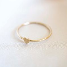 Our handmade 14k Gold Filled Heart Stacker will be a new staple in your ring collection. Simply wear it on it's own or stack together with other rings. Material: 14k Gold Filled Approximately 2mm in thickness. Heart Ring Gold, Minimalist Gold Ring, Dainty Band, Gold Heart Ring, Unusual Rings, Gold Filled Ring, Gold Band Ring, Ring Minimalist, Cute Rings