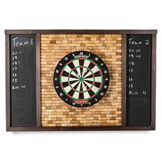 a dart board mounted to the side of a brick wall with chalk writing on it