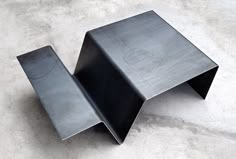 a metal object sitting on top of a cement floor