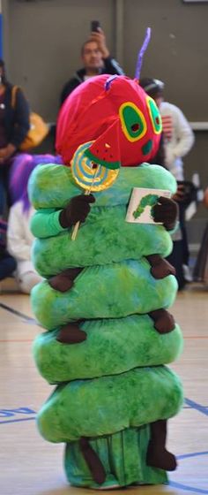 a stack of green items with a red hat on top