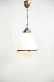 a white and gold light hanging from a ceiling