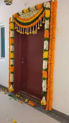 an entrance decorated with flowers and garlands