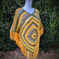 In a world of fast fashion, investing into a handcrafted piece can be rewarding and a better sustainable option.  This is a handmade sunflower poncho crafted with varying stitch types to give it that whimsical boho feel. It also has a hood and tasseled edge.  This is a one of a kind piece, with no plans to remake.   Made with acrylic yarn. Handmade Artisan Poncho For Festivals, Handmade Artisan Poncho For Fall, Handmade Bohemian Poncho For Festival, Bohemian Hand Knitted Poncho For Festivals, Handmade Bohemian Yarn Poncho, Yellow Bohemian Poncho One Size, Bohemian Yellow Poncho One Size, Yellow Bohemian Poncho For Fall, Yellow Bohemian One Size Poncho