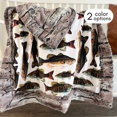 a blanket that has fish on it with two colors options in front of the image