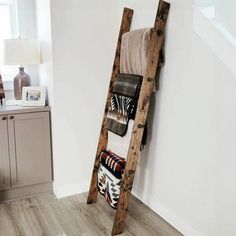 an old wooden ladder is used as a towel rack