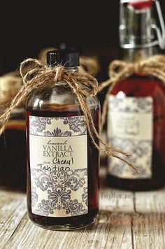 a bottle of vanilla extract sitting on top of a wooden table next to another bottle