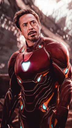 the avengers movie character is looking at something in front of him with glowing lights on his chest