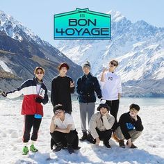 a group of people posing for a photo in front of snow covered mountains with the bon - hoyage logo above them