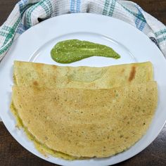 two quesadillas on a white plate with a green pickle