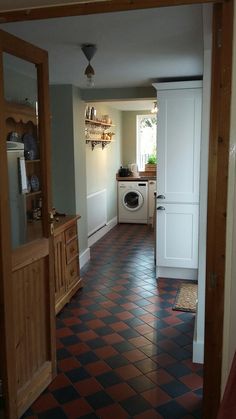 an open door leading to a kitchen with a washer and dryer