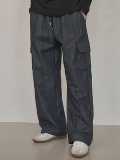 Editor's notesIt is a casual denim pant in non-fade denim fabric that has texture and mood of raw denim but does not bleed. The elastic band on the waist and cargo flap pockets on each side make comfy fit and trendy design. The pant is finished without a washing process so that it does not have any harmful residue on the surface.- Relaxed straight fit- Patch flap pockets- Side pockets- Back pocketMeasurements(in.)M / L- Length: 40.6 in. / 41.1 in.- Waist: 12 in. / 12.8 in.- Hip: 19.3 in. / 20.5 in.- Thigh: 11.8 in. / 12.6 in.- Hem: 9.4 in. / 10 in.- Rise: 13.8 in. / 14.4 in.*Model info: Height 6’ 2” / Fitting size: Size LComposition & Care- 65% Cotton, 35% Polyester- Dry clean recommended- Wash in cold water- Avoid tumble dryDesigner- by WEDNESDAY OASIS Wide Leg Rigid Denim Cargo Pants With Pockets, Indigo Denim Jeans With Pockets, Casual Washed Blue Cargo Jeans With Hip Pockets, Casual Washed Blue Cargo Jeans, Casual Dark Wash Cargo Pants With Hip Pockets, Urban Style Dark Wash Cargo Pants With Hip Pockets, Utility Style Jeans With Side Pockets In Recycled Denim, Medium Wash Rigid Denim Bottoms With Multiple Pockets, Urban Dark Wash Cargo Pants With Hip Pockets