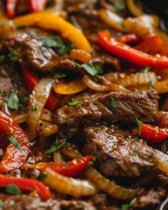 a close up view of some meat and peppers in a skillet with seasoning