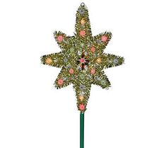 a lighted christmas tree topper on a green pole