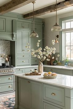 a kitchen filled with lots of green cabinets and white counter tops next to a stove top oven