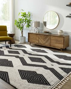 a living room area with a rug, chair and mirror