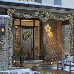 the front porch is decorated for christmas with wreaths and lights