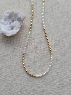 🤍 Beautiful 14k gold fill & fresh water pearl beaded necklace - 6mm 14k Gold Filled spring ring clasp (stamped 14KGF for authenticity) - 3-3.5mm - Potato shape fresh water pearls grade AA - can select your desired length Gold Rondelle Pearl Necklace As Gift, White Single Strand Pearl Necklace With 14k Gold Filled, Everyday Pearl Jewelry With Gold Beads, Dainty Yellow Gold Pearl Necklace With Round Beads, Gold Dainty Rondelle Beaded Necklaces, Everyday Pearl Necklace With Tiny Round Beads, Gold Single Strand Akoya Pearl Beaded Necklace, Gold Akoya Pearl Single Strand Beaded Necklace, Everyday Pearl Necklace With Tiny Beads