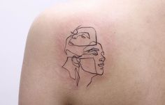 a woman's shoulder with a black line drawing of two women on the side