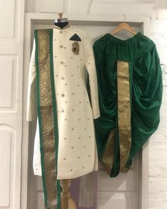 two green and white dresses hanging on a wall