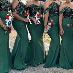 the bridesmaids are wearing green dresses with white sashs and red flowers in their hair