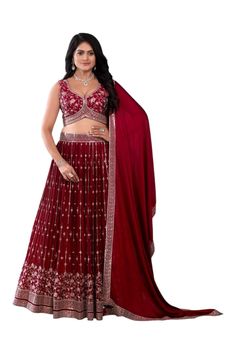 Crimson splendor unfurls as the deep red lehenga set commands attention, its intricate embroidery shimmering like rubies. The heavily embroidered blouse adds a touch of regal elegance, while the tonal dupatta flows like a velvet whisper. This stunning ensemble wraps the little one in a majestic aura of grace and poise, perfect for a tiny queen's grand celebration, exuding confidence and charm. Pre stitched lehenga for women. Crafted from a Georgette fabric for luxurious feel and touch. The blouse features sequin embroidery throughout. The sleeveless blouse features back opening with hook closure and tie ups Dry clean or hand wash for longer life. Note: Colors may slightly vary due to photographic lighting. Please contact us if you have any questions via email, social me Red Party Wear Lehenga With Intricate Embroidery, Party Wear Red Choli For Eid, Party Wear Traditional Dress In Red With Resham Embroidery, Party Wear Red Choli With Intricate Embroidery, Red Party Wear Traditional Dress With Resham Embroidery, Fitted Red Anarkali Set For Party Wear, Red Embroidered Party Wear Sharara, Red Embroidered Choli For Party, Red Embroidered Party Wear Choli