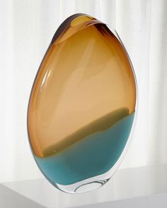 a glass vase sitting on top of a white table