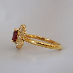 Indulge in timeless romance with the Rosaire spinel ring. Featuring a vibrant spinel center stone in a French-inspired setting, this ring captures and reflects light beautifully, reminiscent of Parisian nights. Crafted with delicate filigree, the Rosaire exudes elegance and vintage charm, making it the perfect symbol of eternal love. Ideal as a gift or a cherished addition to your collection, this stunning ring is a true treasure. All orders come in our Tippy Taste ring box. This ring is handmade and designed in NYC. 14K or 18K solid gold Natural oval red spinel, 5*4mm 12 Natural round diamonds. SI clarity, GH color, 0.1ct total carat weight 1.5mm ring band ** Tippy Taste Heirloom Collection is made to order. Please allow 3-4 week turnaround time. Shipping:Domestic: Free shippingInternatio Red Spinel, Spinel Ring, Charm Making, French Inspired, Ring Band, Ring Box, Vintage Charms, Round Diamonds, Solid Gold