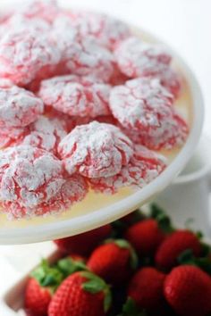 strawberry shortcakes on plates with strawberries in the foreground and another plate behind them