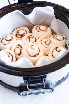 several rolls in a crock pot on a table